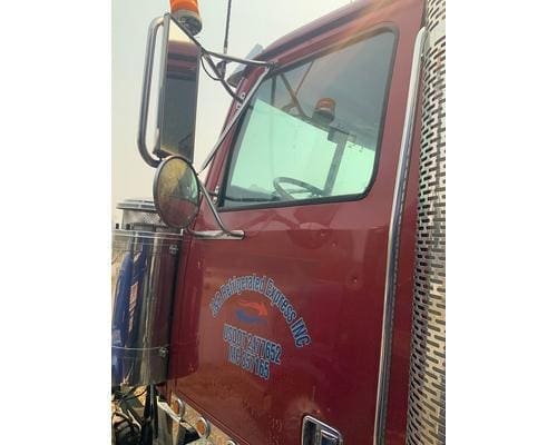Driver side manual door assembly with mirror from a 2002 Western Star 4964EX